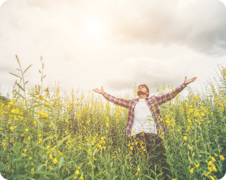 Person with arms raised in a field