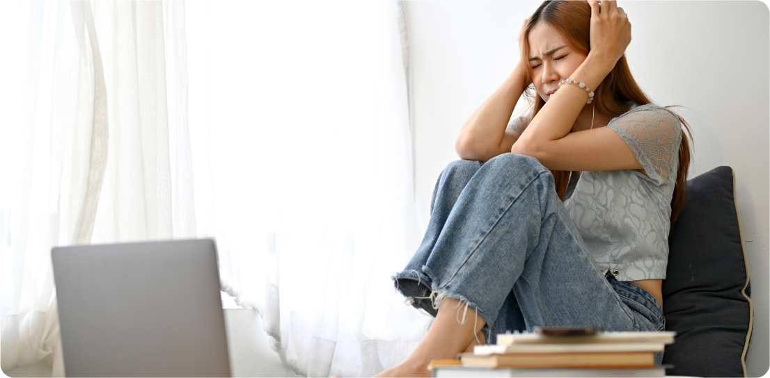 Patient showing signs of distress while sitting with laptop