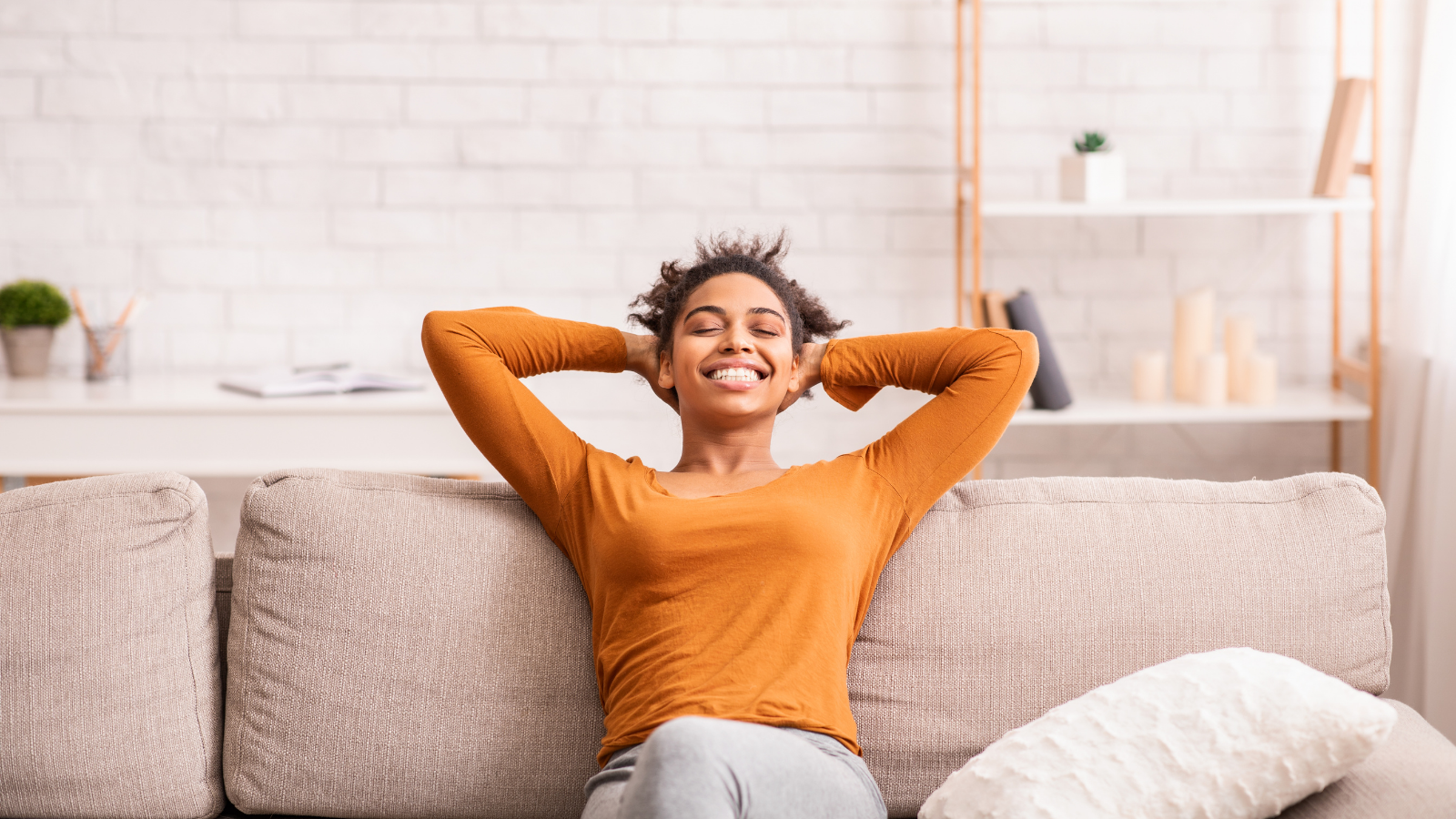 Woman relaxing in a comfortable chair with plants in background