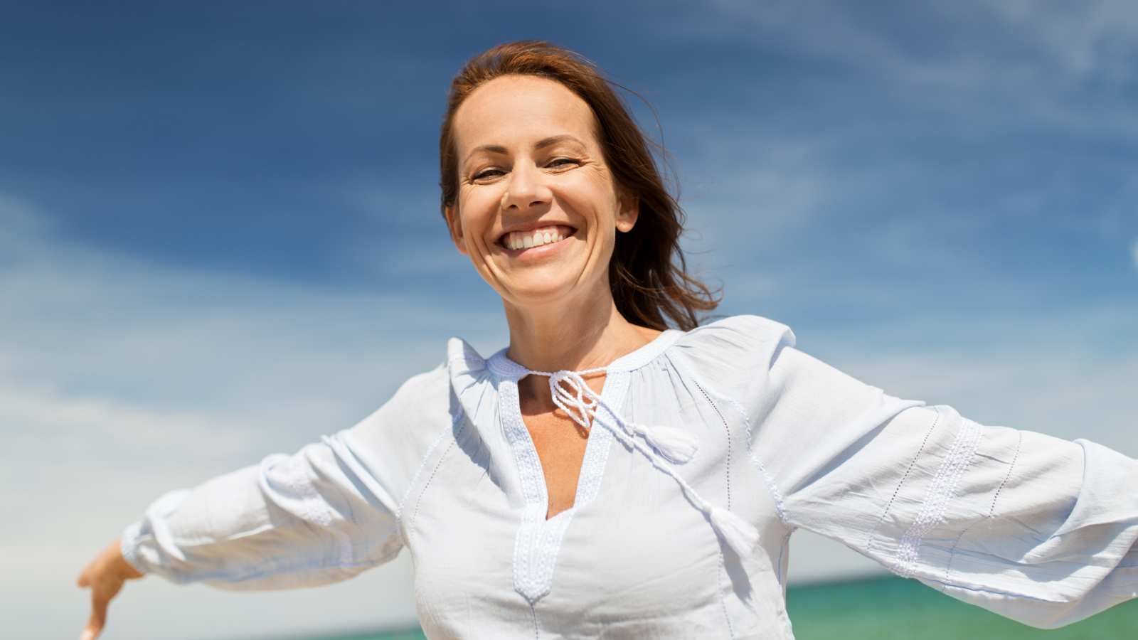 Woman relaxing in a comfortable chair with plants in background